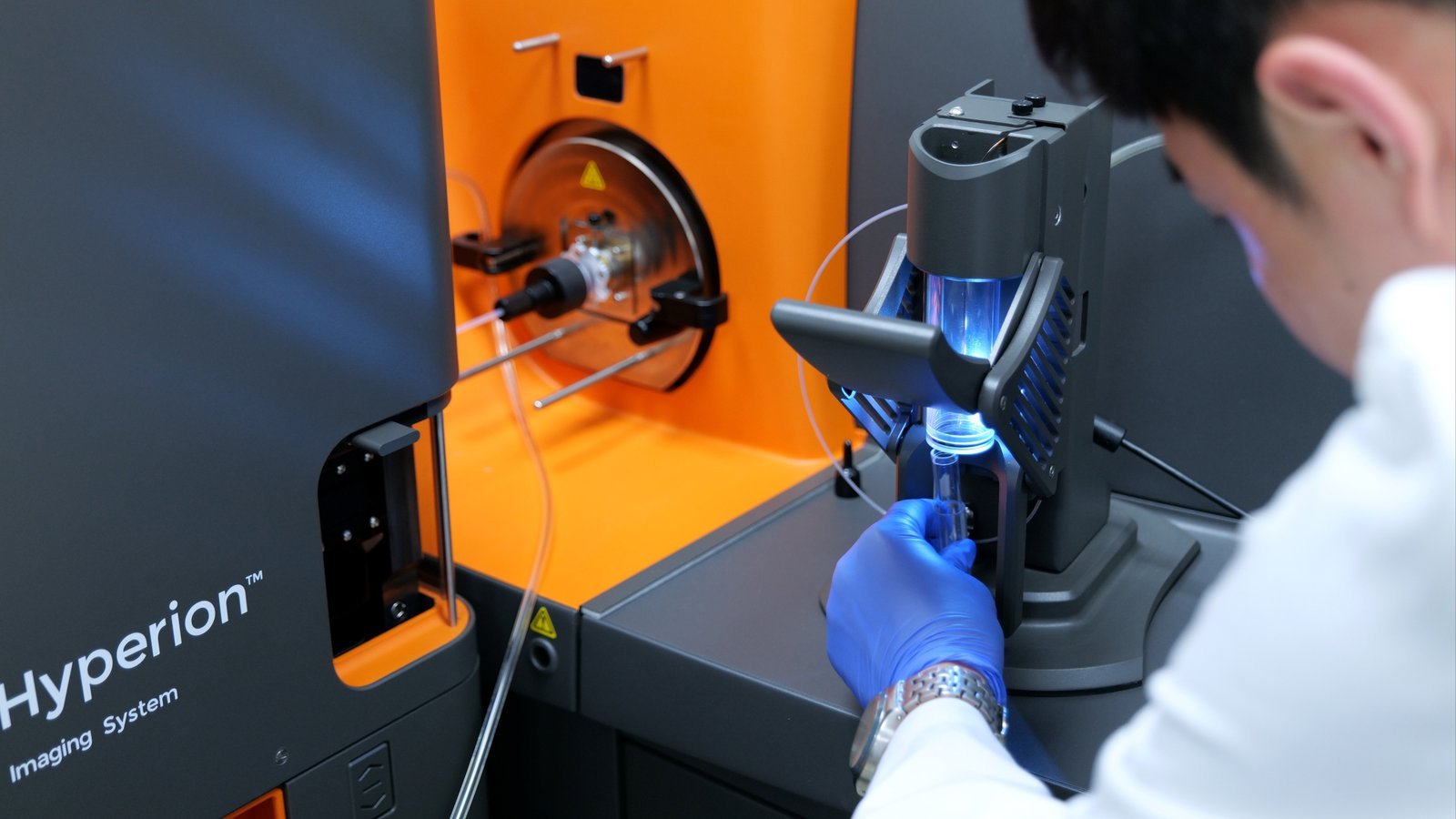 Researcher mounting a specimen slide in front of the Hyperion Imaging System