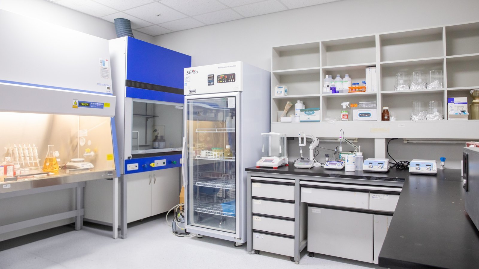 Media preparation room overview - biological safety cabinet, fume hood, refrigerator, pH meter